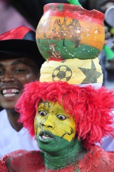 Ghanaian supporters cheer prior to their Group D first round 2010 World Cup football match on June 23, 2010 at Soccer City stadium in Soweto, suburban Johannesburg. NO PUSH TO MOBILE / MOBILE USE SOLELY WITHIN EDITORIAL ARTICLE AFP PHOTO / JOHN MACDOUGALL