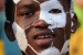 A boy with a football painted on his face cheers prior to the 2010 World Cup round of 16 match Netherlands vs Slovakia on June 28, 2010 at Moses Mabhida stadium in Durban. NO PUSH TO MOBILE / MOBILE USE SOLELY WITHIN EDITORIAL ARTICLE AFP PHOTO / CARL DE SOUZA