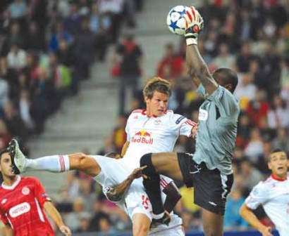 Hapoel Tel Aviv’s Goalkeeper, Nigerian Vincent Enyeama (right) saves the ball amidst struggle with Red Bull Salzburg’s Franz Schiemer during their UEFA Champions League Play-off first-leg round football match in Salzburg on 18 August, 2010. PHOTO: AFP.