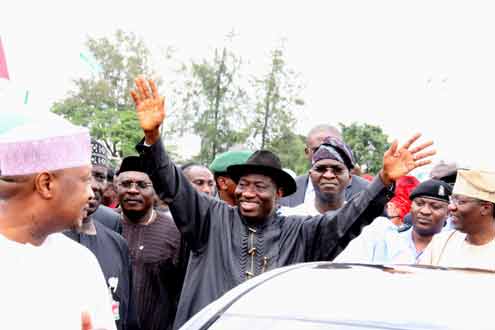 President Goodluck Jonathan acknowledging cheer from the crowd during his visit to Lagos this morning. With him on the right is Gov. Babatunde Fashola of Lagos State, Nigeria. PHOTO: OLATUNJI OBASA.