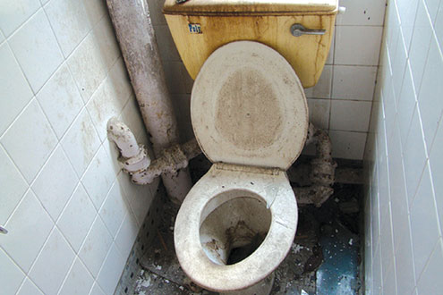 One of the dirty toilets in an eatery.