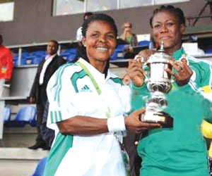 Super Falcons’ captain Uzoaru Precious Dede and Coach Eucheria Uche display the team’s Fair Play Award.