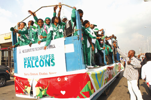 Super Falcons acknowledge cheers from Lagos fans after their arrival at the Murtala Mohammed International Airport, Ikeja, Lagos, Nigeria on Monday. Photo: Emmanuel Osodi.