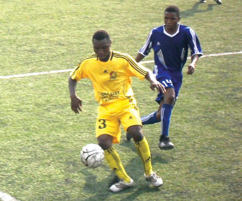 ON COURSE:Emmanue Njoku of Eti Osa East (Yellow) moves ahead with the ball while Adewuyi Ahmed of Nath Boys trails him during weekendâ€<img src=