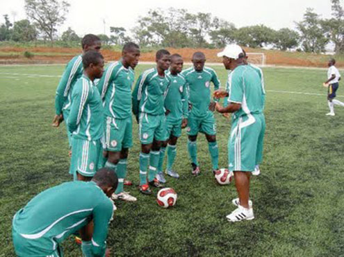 Flying Eagles listen to Coach John Obuh during a training session.