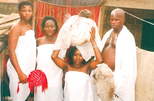 The fake herbalist performing rituals on the ladies.