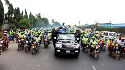 Lagos State Governor, Mr. Babatunde Fashola (SAN),  his running mate, Hon Adejoke Orelope-Adefulire acknowledging cheers from commercial motorcycle (Okada) and supporters of the Action Congress of Nigeria (ACN) during the partyâ€™s campaign rally in Alimosho, Igando road, Alimosho, Lagos, on Friday, March 18, 2011.
