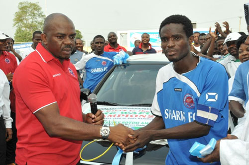 Hon Boma Iyaye,commisioner for sports here presenting the nissan sunny car key to Mr Odinga odinga,captain sharks football club of port harcourt during the handingover ceremony at sharks stadium port harcourt.
