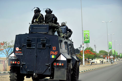 Police patrol a deserted street in Bauchi. AFP PHOTO.