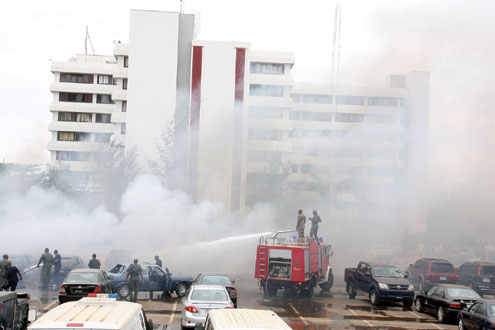 â€¢Fire fighters combating the inferno arising from the bomb explosion at the car park of Police Headquarters, Louis Edet House, Abuja, Nigeria, this morning. PHOTO: FEMI IPAYE.