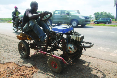 Ahmed,15yrs old with his generator self made car along Airport road, Abuja, this morning
