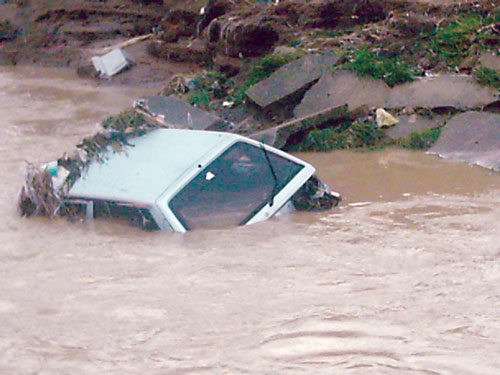 A car being washed away in the flood