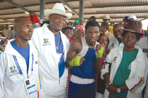 Olayide Fijabi (middle) celebrates after winning a gold medal in the boxing event of the Garden City Games with other members of Team Lagos in Port Harcourt.