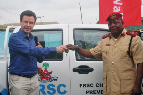 RegisTromeur handing over the keys of the truck to Jonas  Agwu.