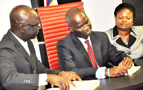 Lagos State Governor, Mr. Babatunde Fashola SAN (middle), signing the Law to Amend the Lagos State Emergency Management Agency (LASEMA), Law to Provide Rules on Criminal Conduct, Regulate Public Order and for Connected Purposes and Law on Criminal Justice Administration in the High Courts and Magistrates Courts of Lagos State and for Other Connected Purposes at the Conference Hall, Lagos House Ikeja, on Monday, August 8, 2011. With him are: Deputy Governor, Princess Adejoke Orelopeâ€“Adefulire (right) and Attorney General and Commissioner for Justice, Mr. Ade Ipaye (left).