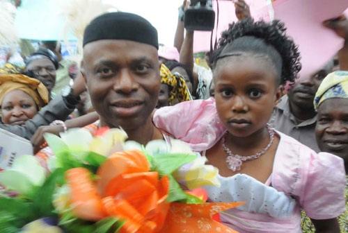 Ondo State Governor, Dr Olusegun Mimiko (L) with little Miss Precious Akinsanmi during the commissioning of Accelerated Rural Water Supply Scheme otherwise known as “KAMONI†in Ajowa-Akoko on Friday.