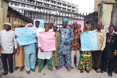 NIPOST pensioners postesting over non-payment of their wages at the General Post Office, Merina, Lagos, this morning. PHOTO: ABEEB OGUNBADEJO