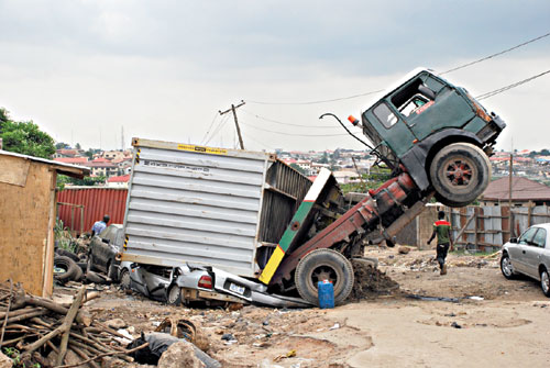 The truck carrying a container that fell on four cars at Agidingbi, Ogba, Ikeja, Lagos, yesterday. PHOTO: OGUNBADEJO ABEEB