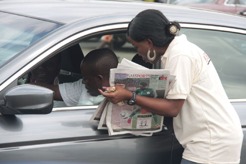 â€¢An accountant with ICNL, publishers of TheNEWS/P.M.NEWS/A.M.SPORTS selling compies of  A.M.SPORTS to a motorist on the street of Lagos this morning. PHOTO: IDOWU OGUNLEYE.