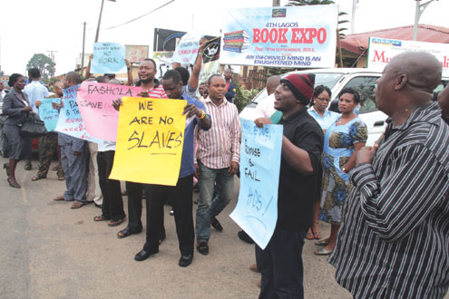 Some staff of Lagos Television and Radio Lagos protesting against non-payment of the N18,000 minimum wage at their Ikeja, Lagos office, this morning. PHOTO: IDOWU OGUNLEYE.