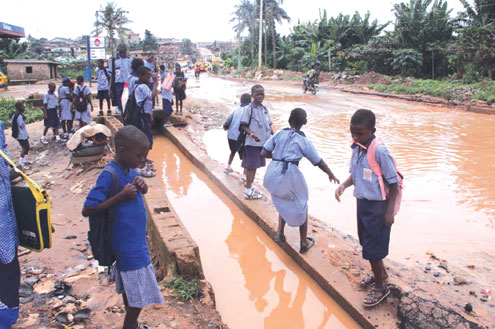 Pupils returning from school on the horrible Iju/Ajuwon Road.