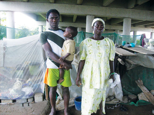 The couple and child at their place of abode under the bridge. PHOTO: AYODEJI DEDEIGBO.