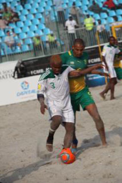 Ogbonnaya Okemiri (front) of Nigeria is tackle from  behind by Ryle Penn of South Africa, during their Copa Lagos Beach Soccer opening match at Eko Atlantic Beach, Victoria Island,  Lagos. Nigeria won by 7-3. Photo… courtesy DSTV