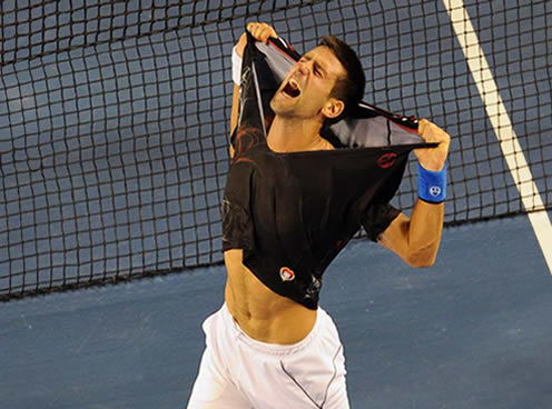 EXCITEMENT...Novak Djokovic of Serbia rips his shirt off as he celebrates his victory over Rafael Nadal of Spain in the men's final of the 2012 Australian Open on 30 January, 2012. Djokovic won 5-7, 6-4, 6-2, 6-7, 7-5. PHOTO: AFP.