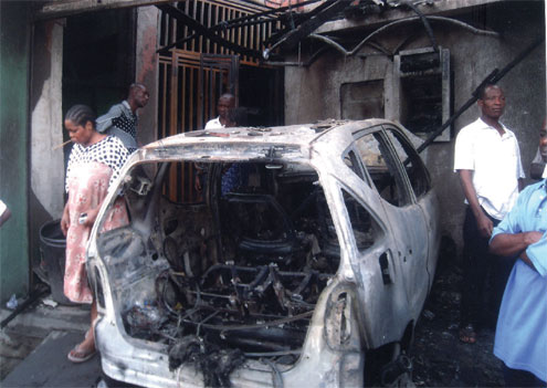 One of the vehicles burnt by the rampaging youths on Lagos Island, this morning .