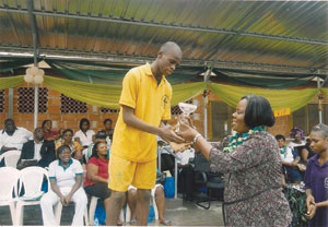 Ogo Oluwa Adenuga (left) is being presented with a trophy during Doregos Private Academy’s Sports Day in Lagos.