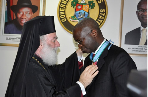 Lagos State Governor, Mr. Babatunde Fashola SAN (right) being decorated with the Lion of Alexandria Medal by the Pope of the Coptic Orthodox Church of Alexandria, Pope Theodore ll (left) during his courtesy visit to the Governor at the State House, Alausa-Ikeja, Lagos, on Monday, February 20, 2012.