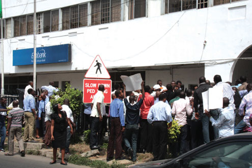 Disengaged Oceanic Bank workers protesting in front of Ecobank on Ozumba Mbadiwe Street, Victoria Island, Lagos, this morning. PHOTO: IDOWU OGUNLEYE.