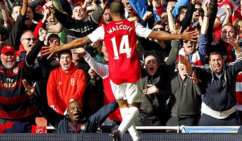 Walcott celebrates with Arsenal fans.