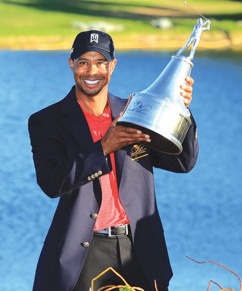 Woods proudly holds the trophy presented by MasterCard. PHOTOS: AFP.