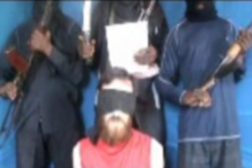 Video plea: One of the hostages is seen pleading for his life as his armed captors stand behind him in a video released by the kidnappers