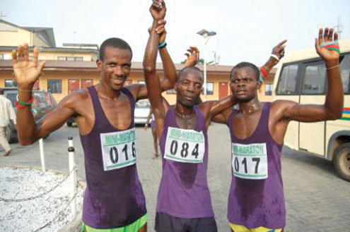 Winner of the just concluded Ayodele Adewale 12KM Marathon Race, Femi Olusanya (middle) celebrating with other athletes.
