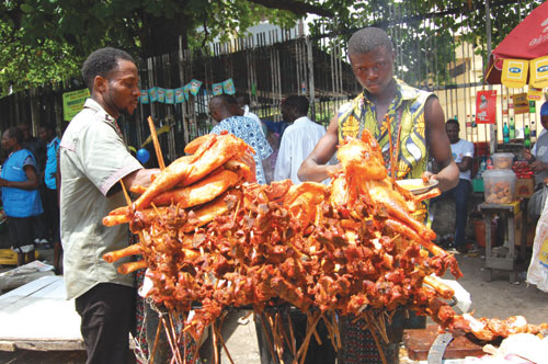 Roasted chicken being sold openly at Obalende bus stop this morning. PHOTO: ABEEB OGUNBADEJO.