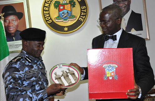 Lagos State Governor, Mr. Babatunde Fashola SAN (right), presenting a souvenir to the Inspector-General of Police, Mr. Mohammed Dahiru Abubakar (left) during a courtesy visit to the Governor at the State House, Ikeja, Lagos on Monday, May 21, 2012.