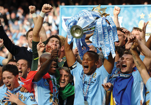 CELEBRATION…Manchester City’s Belgian captain Vincent Kompany and teammates lift the English Premier League trophy after their 3-2 victory over QPR in the last match of the season at The Etihad stadium in Manchester, north-west England on 13 May, 2012. City won 3-2 to secure their first title since 1968.