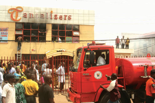 Men of the Lagos State Fire Service trying to put out the fire that gutted the Ogba Ijaiye branch of Tantalizers, a fast food outlet this morning. Photo:Oluwasanmi   JOSEPH.