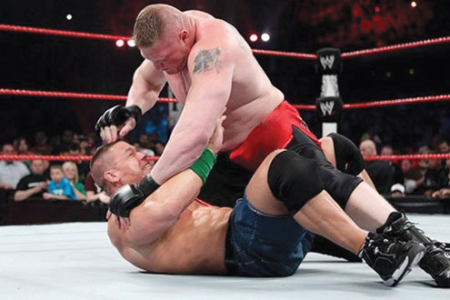 John Cena (down) is floored by an opponent at the Extreme Rules bout held in Chicago recently.