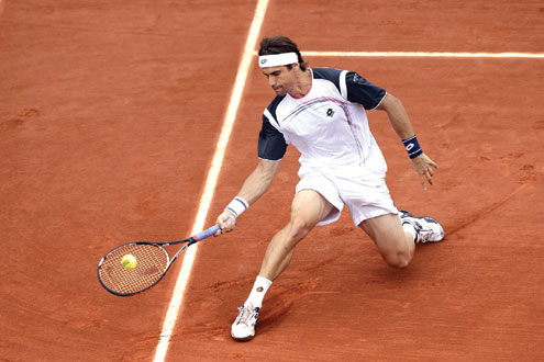 RETURN… Spain’s David Ferrer hits a return to British’s Andy Murray during their men’s quarter final tennis match of the French Open tennis tournament at the roland Garros stadium yesterday. Photo: AFP.