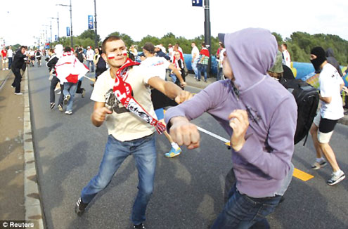 Polish and Rushian fans fight during yesterday's match.