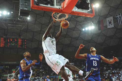 Olumide Oyedeji (15) of Nigeria dunks against Dominican Republic during their Pre-Olympic basketball game in Caracas on 8 July, 2012. Nigeria won 88-73 points and qualified for their first-ever Olympic Games. Photo: AFP.