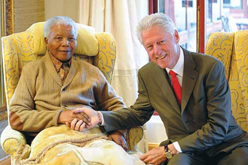 File photo: Bill Clinton in a handshake with Mandela a former Nobel Peace Winner