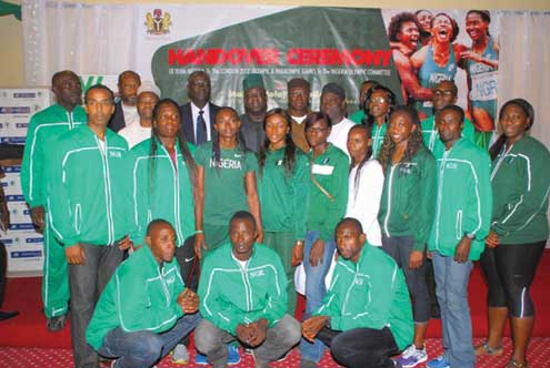 Some athletes of the Team Nigeria in group photograph with the Sports Minister, Bolayi Abdulahi during the hand over ceremony in Lagos.