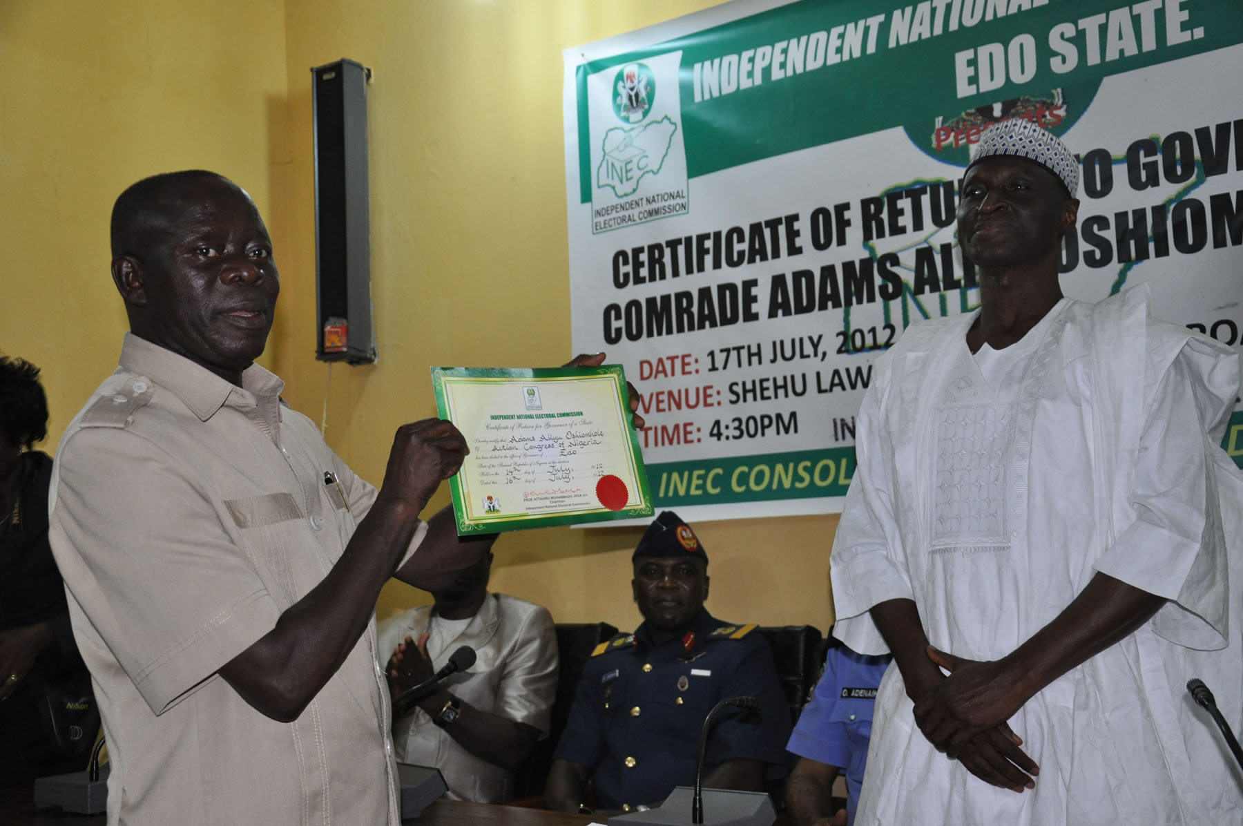 oshiomhole displaying his election certificate