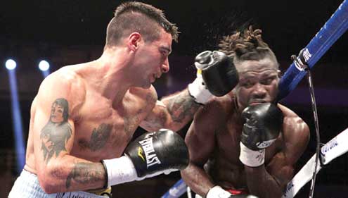 Nigeria’s Olusegun Ajose (r) receives punches from Argentina’s Lucas Mattysse during their WBC world title bout in the US 8 September.