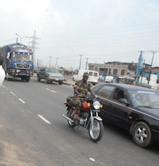a soldier riding Okada on a major highway in Lagos in defiance of the Traffic Law