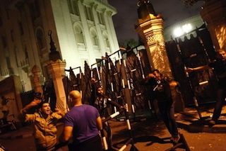Spirit of protest: demonstrators remove the barrier in fron of the palace gate